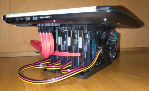 A laptop with a DIY HDD cage carrying 4 HDDs.